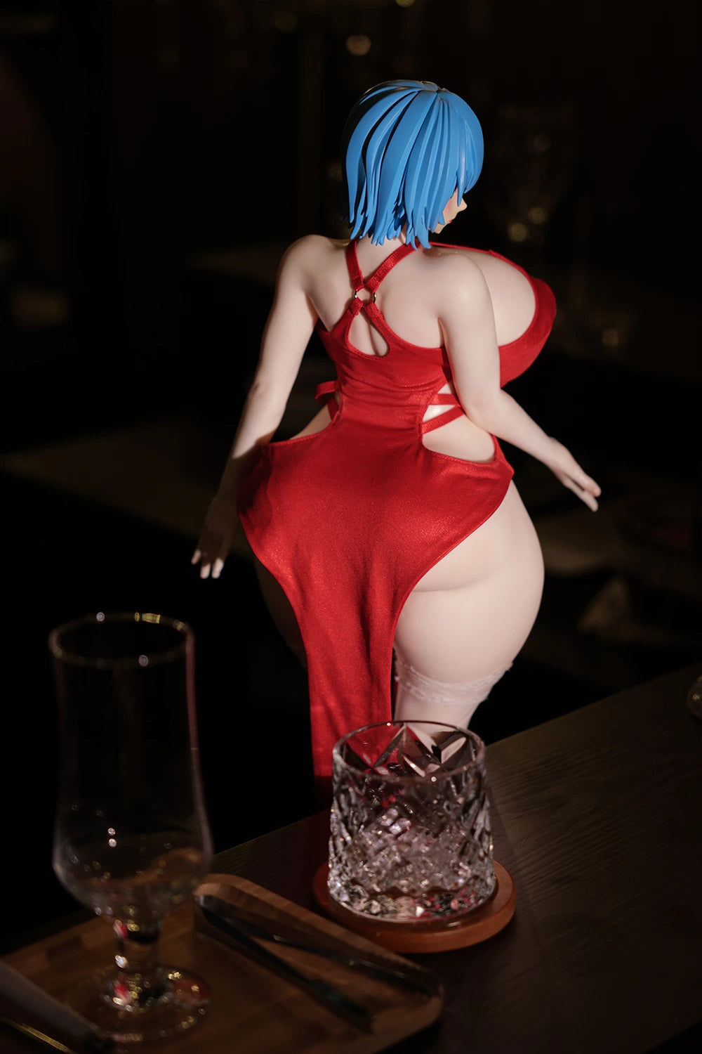 Rear view of the Akeno anime figure wearing a red dress in a dimly lit.